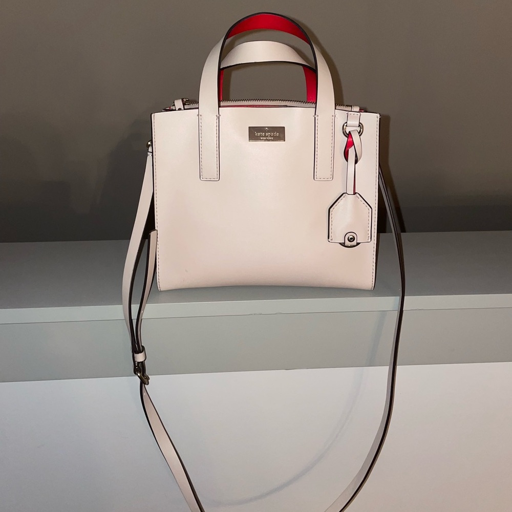 kate spade purse, crème color with red on the inside. It will come with a wallet